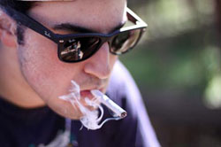 boy smoking a joint in ann arbor michigan at hash bash 2012