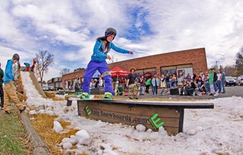 girl snowboarder at outdoor action company in kego harbor michigan